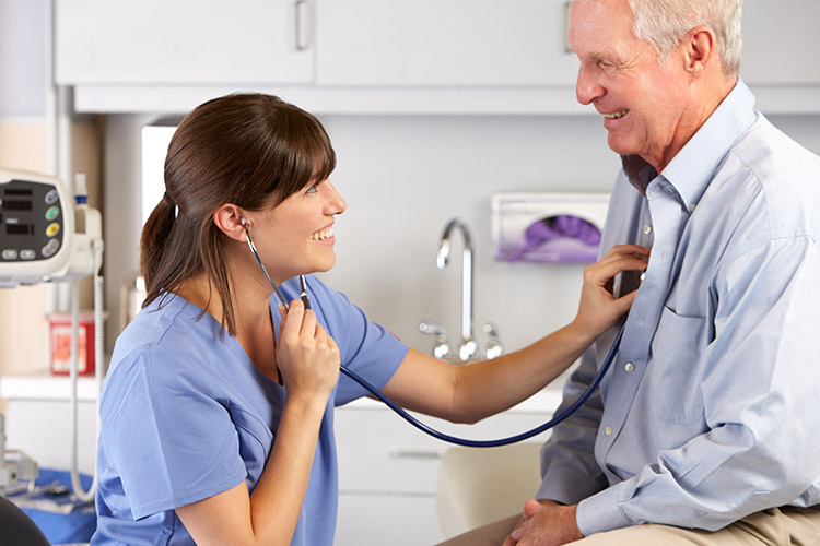 Doctor Listening To Male Patient's Chest